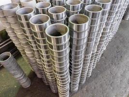 stacks of many siny steel sleeve parts after cnc turning operations photo