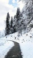 Walkway hiking epic mountain outdoor adventure to destination the old salt mine of Hallstatt pass the pine forest and Winter snow mountain landscape outdoor adventure, Austria photo