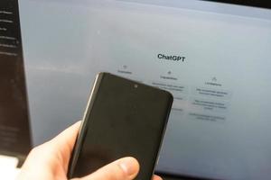 Kyiv, Ukraine - February 08, 2023 Webpage of ChatGPT, a prototype AI chatbot, is seen on the website of OpenAI, on a smartphone. Examples, capabilities, and limitations are shown before a new chat. photo