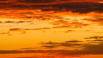 Background image with clouds in extreme colors of a sunset. The sky seems to burn photo