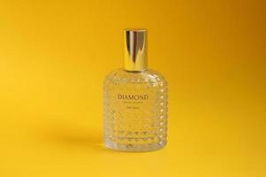 West Jakarta, Indonesia - February 10th, 2023 - Eau de toilette beautiful fragrant perfume in elegant glass bottle. Photo isolated on yellow background. Diamon perfume 50 ml.