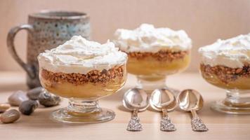 Apple compote dessert with three silver spoons in a row. photo