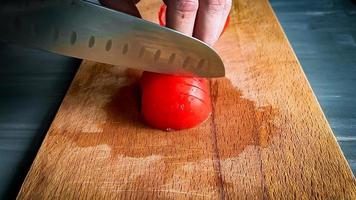 slicing red tomato photo