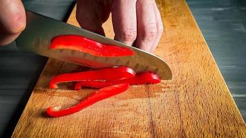 slicing red pepper. hands holding pepper photo