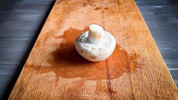 mushrooms on a wooden board. mushrooms on a cutting board. photo