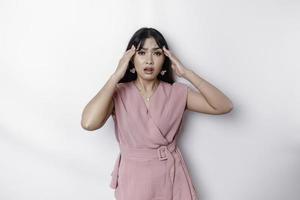 A portrait of an Asian woman wearing a pink blouse isolated by white background looks depressed photo