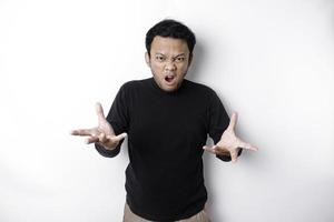 The angry and mad face of Asian man in black shirt isolated white background. photo