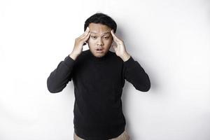 A portrait of an Asian man wearing a black shirt isolated by white background looks depressed photo
