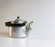 Old soldier's aluminum teapot from the Second World War on a white background. photo