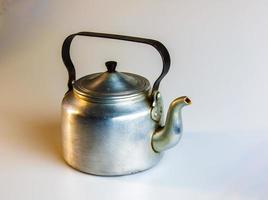 Old soldier's aluminum teapot from the Second World War on a white background. photo