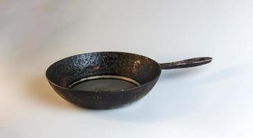 An old cast iron skillet made in circa 1960 against a white background. photo