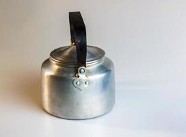 Old soldier's aluminum teapot from the Second World War on a white background. photo