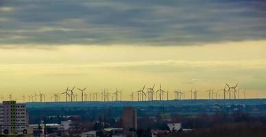 Wind farm or wind farm at sunset in cloudy weather in Austria in Europe, allows you to get clean energy. It's sustainable, renewable energy for the environment photo