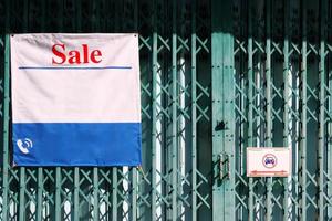 Sale Sign of Commercial Building on Folding Door. photo