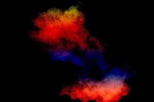 Colorful background of pastel powder explosion.Multi colored dust splash on black background. photo