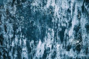 White paint on a dark blue wall background. photo