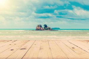 Abstract blurred sea and island with wood table for vintage background. photo