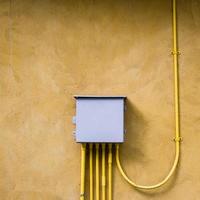 control electrical box on yellow wall background. photo