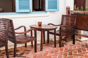 old wooden chair with wooden table at home photo