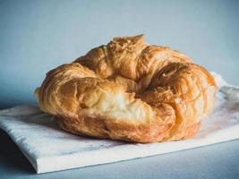 fresh croissants on fabric gray background photo