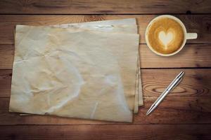 old paper and coffee on wood table texture with space for text photo