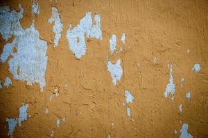 Old grunge yellow wall background and texture photo