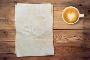 old paper and coffee on wood table with space. photo