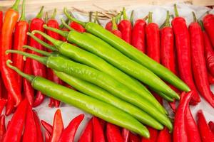 red pepper and green pepper on shelf in market. photo