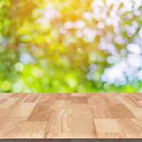 wood table and green leaf bokeh blurred for nature background photo