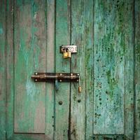 grunge door green double lock and background. photo