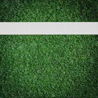 White stripe on the green soccer field from top view photo