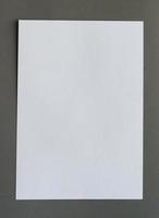 White crumpled paper on gray background vertical photo