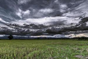 Storm Clouds before rainy and field meadow photo