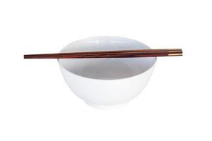 close up chopsticks and white bowl isolated on white. photo