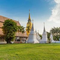 The golden pagoda at Wat Suan Dok, Chiang mai, Thailand, with beautiful blue sky. photo