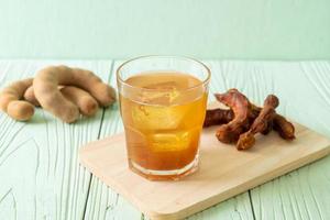 Delicious sweet drink tamarind juice and ice cube photo