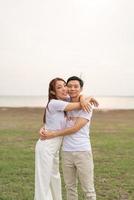 Happy young Asian couple in bride and groom t-shirt photo