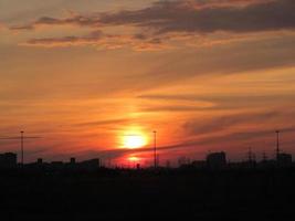 Beautiful sunset over silhouette city skyline photo