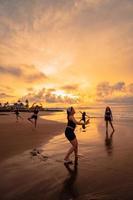 a group of Asian women dancing together and full of joy on the beach photo