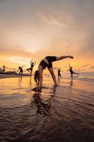 a group of Indonesian women doing gymnastic exercises very agile on the beach photo