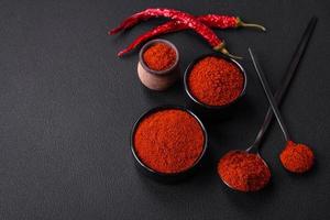 Spice smoked paprika in the form of powder in bowls and spoons photo