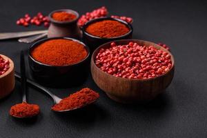 Spice smoked paprika in the form of powder in bowls and spoons photo