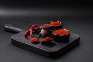 Spice smoked paprika in the form of powder in bowls and spoons photo