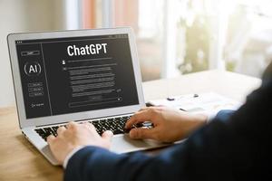 Data search concept using artificial intelligence chatbot ChatGPT, young businessman chatting with smart chatbot To find business economic information, artificial intelligence developed by OpenAI. photo