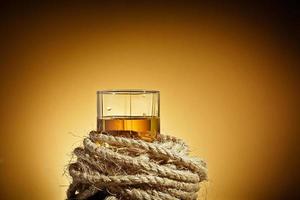 Glass of whiskey and a rope photo