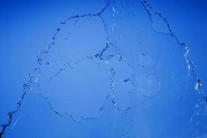 Falling water on a blue background photo