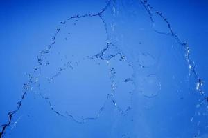 Falling water on a blue background photo