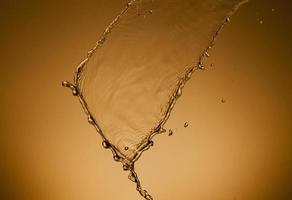 Falling water on a golden background photo