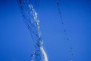 Falling water on a blue background photo