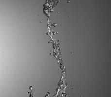 Falling water on a silver background photo